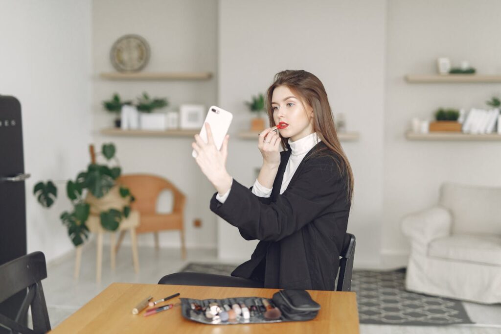 Young lady having video call on smartphone at home