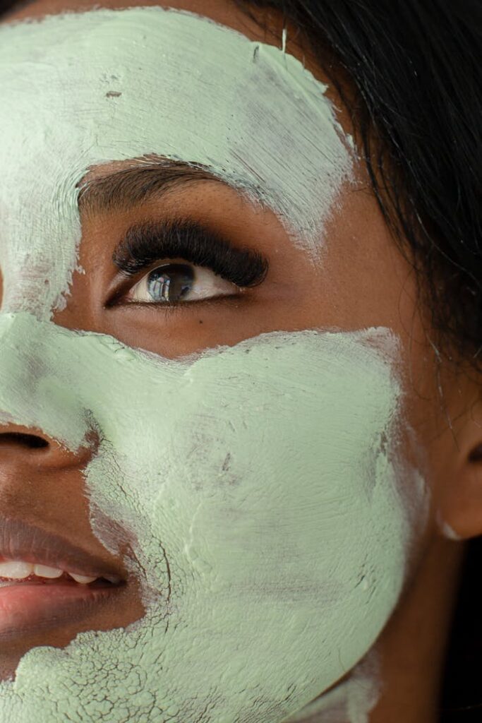 Anonymous black woman with clay mask